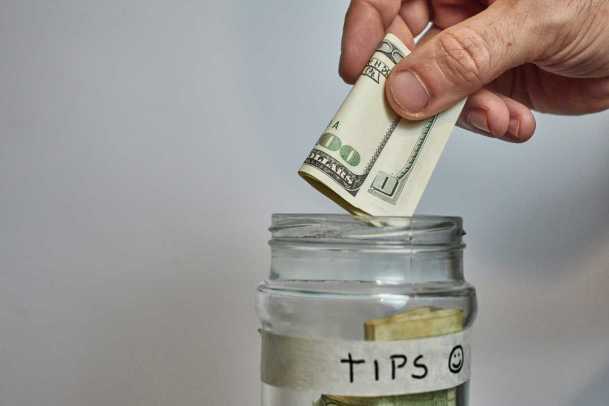 Putting money in an acupuncture tip jar